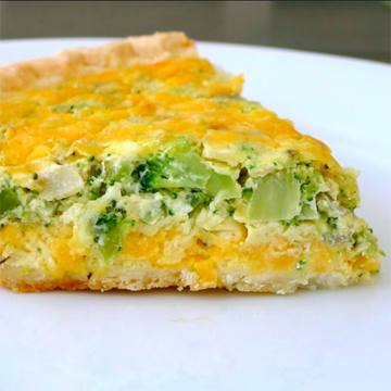 Crusty golden yellow cheese quiche with moist broccoli inside